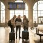 Travelers navigating European train station together
