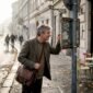 Historian walking along Budapest river street