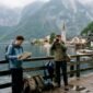 Travelers overlooking Hallstatt village from ferry dock