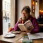 Traveler reading guidebook in Prague café