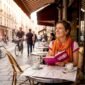 Traveler journaling outside European café