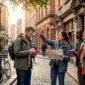 Travelers with guide on European city street