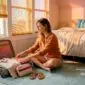 Woman packing suitcase for summer trip