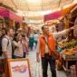 Travel guide leading tourists in city square