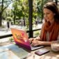 Traveler booking tours on laptop at cafe