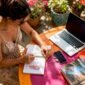 Woman planning custom travel itinerary at home