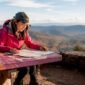 1781336082703_Woman examining map in forest trailhead 85x85