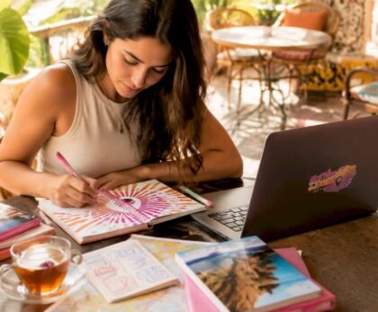 Woman planning travel itinerary at kitchen table