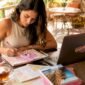 1781421247206_Woman planning travel itinerary at kitchen table 85x85
