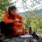 1782538850253_Traveler organizing hiking gear at trailhead 85x85