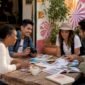 Travelers planning European city trips in agency lobby