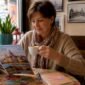 1784741224531_Woman browsing Austria tours at cafe 85x85