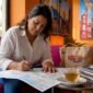 Travel agent planning tour itinerary at desk