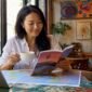 1785532257354_Asian woman planning group tour at home table 85x85