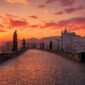 Empty Charles Bridge at sunrise with Prague Castle