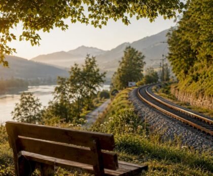 Railway track along Austrian valley at sunset