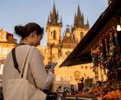 Traveler consulting map in Prague square