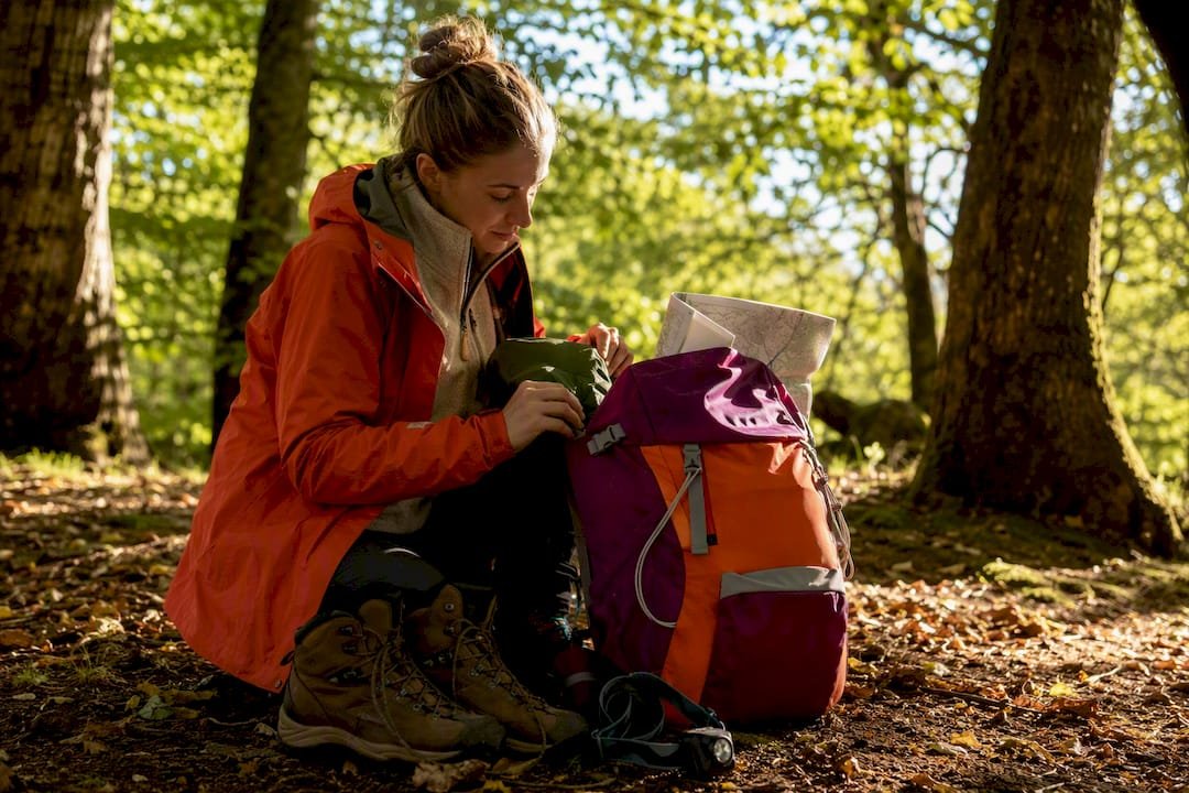 Packing hiking gear on bench outdoors