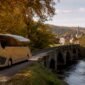 1787245425473_Tour bus driving through European countryside 85x85