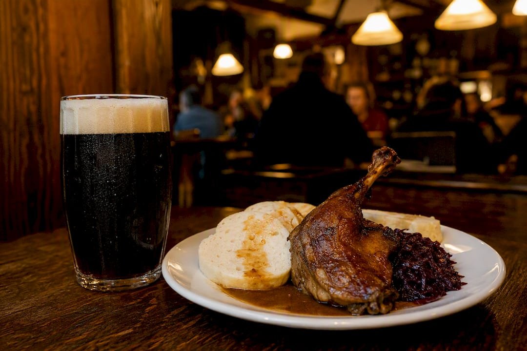 Czech roast pork meal with dark lager beer
