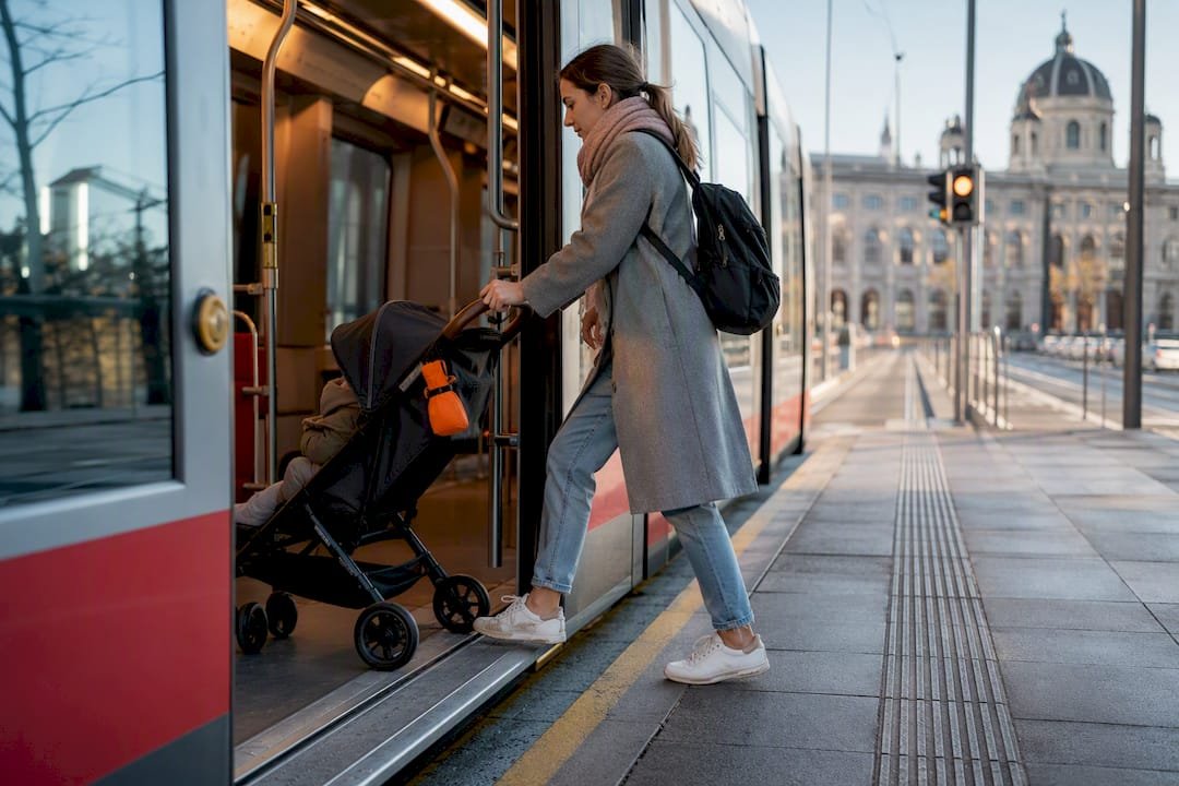 Parent boarding Vienna tram with stroller
