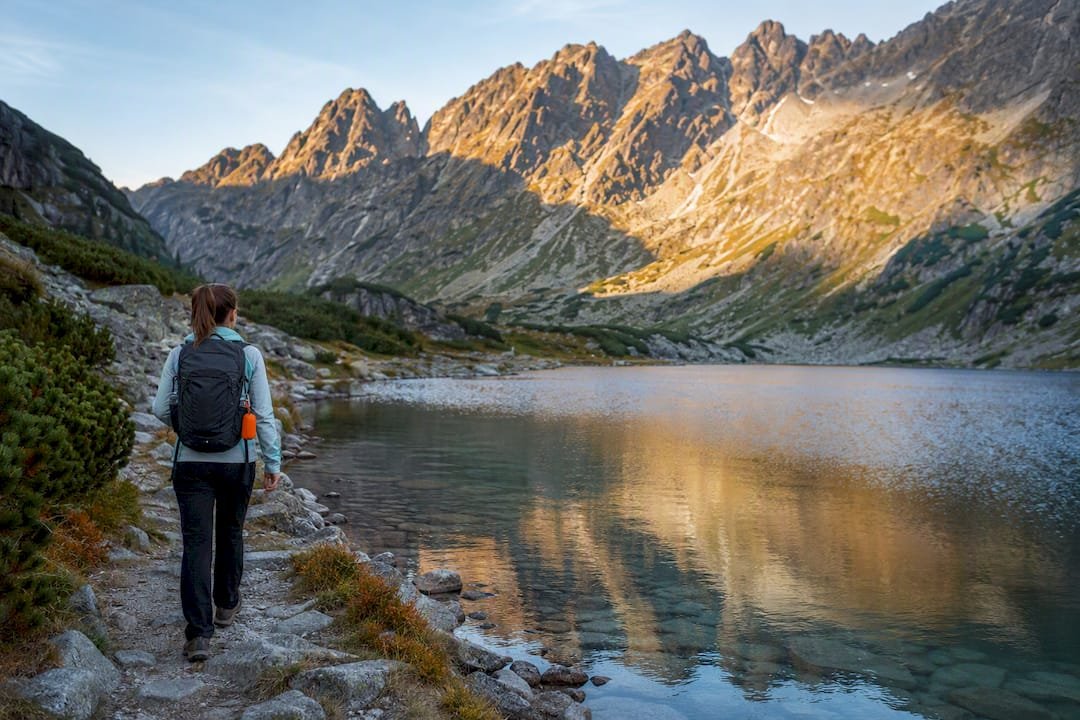 Hiker beside a High Tatras mountain lake