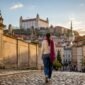 1788979102635_Traveler walking Bratislava Old Town beneath castle 85x85