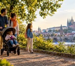 Family strolling through a Prague park